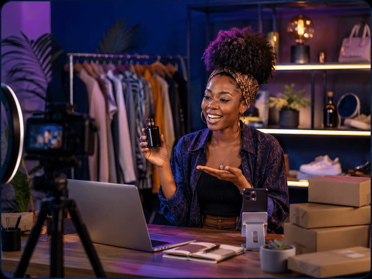 Smiling Black woman with an afro records a product review in her home studio.